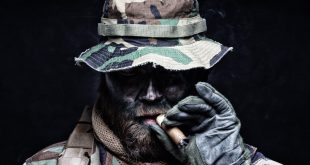 a-soldier-in-camo-smokes-a-cigar
